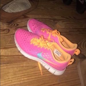 Nike tennis shoes and tanks and a smart phone